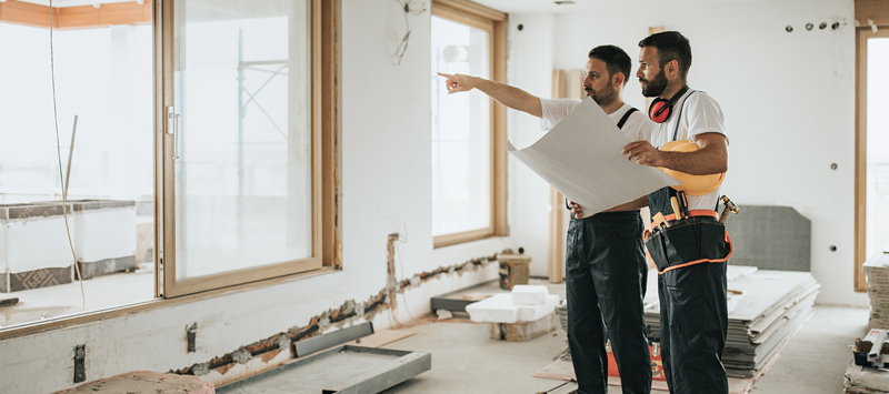 Two male contractors working on a home renovation 