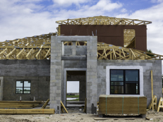 New home construction with frame roof and concrete block below